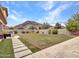 Expansive backyard with lush lawn, mature trees, and stunning mountain views at 5812 W Spur Dr, Phoenix, AZ 85083