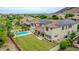 Amazing view of backyard with solar panels, a pool, and a well-maintained lawn, perfect for outdoor entertainment at 5812 W Spur Dr, Phoenix, AZ 85083