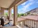 Outdoor balcony seating with views of the mountains and nearby homes at 5812 W Spur Dr, Phoenix, AZ 85083