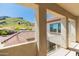 A charming balcony reveals neighborhood views with rooftops against a scenic mountain backdrop at 5812 W Spur Dr, Phoenix, AZ 85083