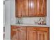 Kitchen wet bar features wood cabinetry, drawers and counter for entertaining at 5812 W Spur Dr, Phoenix, AZ 85083