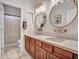 Modern bathroom features wood cabinets, dual sinks, granite countertop and decorative mirrors at 5812 W Spur Dr, Phoenix, AZ 85083