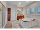 A bright bathroom offers a soaking tub, and a tiled shower with a glass door at 5812 W Spur Dr, Phoenix, AZ 85083