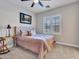 Inviting bedroom features plush carpeting, natural light, and a cozy armchair at 5812 W Spur Dr, Phoenix, AZ 85083