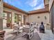 Serene courtyard featuring a fireplace, outdoor seating, and tasteful decor elements at 5812 W Spur Dr, Phoenix, AZ 85083
