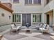 Inviting courtyard with comfortable seating, a fireplace, and views of the home's architecture at 5812 W Spur Dr, Phoenix, AZ 85083