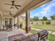 Large covered patio complete with ceiling fans, stone columns, outdoor seating, and desert views at 5812 W Spur Dr, Phoenix, AZ 85083