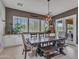 Elegant dining room with dark wood table, bench seating, and ample natural light from large windows at 5812 W Spur Dr, Phoenix, AZ 85083