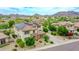 A well-manicured lawn and charming stone accents highlight the home's attractive facade, complemented by solar panels at 5812 W Spur Dr, Phoenix, AZ 85083