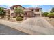 Beautiful home featuring stone accents, a spacious driveway, three-car garage and expertly landscaped surroundings at 5812 W Spur Dr, Phoenix, AZ 85083