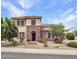 Charming two-story home featuring a stone and stucco facade, landscaped yard, and a welcoming arched entryway at 5812 W Spur Dr, Phoenix, AZ 85083