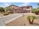 Exterior of a two-story home with stone accents, three-car garage, and a long driveway at 5812 W Spur Dr, Phoenix, AZ 85083