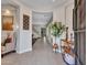 Spacious foyer with tiled flooring, decorative console table with mirror, and ample natural light from shuttered windows at 5812 W Spur Dr, Phoenix, AZ 85083
