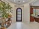 Inviting foyer with neutral walls, tile flooring, arched doorway, and stylish decor at 5812 W Spur Dr, Phoenix, AZ 85083