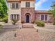 Beautiful home exterior with lush landscaping, a stone facade, and a welcoming brick pathway at 5812 W Spur Dr, Phoenix, AZ 85083