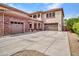 Three car garage with stone accents and plenty of driveway space and an upstairs balcony at 5812 W Spur Dr, Phoenix, AZ 85083
