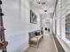 Hallway featuring neutral walls, modern lighting and a bench at 5812 W Spur Dr, Phoenix, AZ 85083