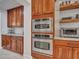 Kitchen featuring wood cabinetry, stainless steel appliances, and floating wood shelves at 5812 W Spur Dr, Phoenix, AZ 85083