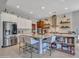 Bright kitchen with stainless steel appliances, large island with seating, and modern cabinetry at 5812 W Spur Dr, Phoenix, AZ 85083