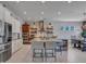 Spacious kitchen features stainless steel appliances, white cabinetry, and a large island with seating at 5812 W Spur Dr, Phoenix, AZ 85083