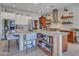 Modern kitchen with a large island, seating, white cabinets, stainless steel appliances, and stylish shelving at 5812 W Spur Dr, Phoenix, AZ 85083