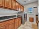 Well-organized laundry room with ample storage and modern appliances at 5812 W Spur Dr, Phoenix, AZ 85083