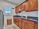 Functional laundry room with built-in cabinets, sink, and modern washer/dryer at 5812 W Spur Dr, Phoenix, AZ 85083