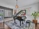 Well-lit living room showcases a grand piano, gray walls, plantation shutters, and elegant furnishings at 5812 W Spur Dr, Phoenix, AZ 85083