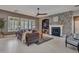 Spacious living room showcases stone fireplace, shuttered windows, tile floor, and stylish furnishings at 5812 W Spur Dr, Phoenix, AZ 85083