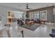Open living room featuring neutral paint, large windows, tile flooring, and views into the kitchen and dining area at 5812 W Spur Dr, Phoenix, AZ 85083