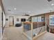 Spacious loft area with plush carpeting, ceiling fan, and wrought iron railing at 5812 W Spur Dr, Phoenix, AZ 85083