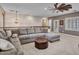 Spacious loft area with a large sectional sofa, ottoman, and carpeting at 5812 W Spur Dr, Phoenix, AZ 85083