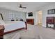 A luxurious main bedroom features an en-suite bathroom and a wall-mounted TV at 5812 W Spur Dr, Phoenix, AZ 85083