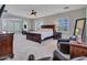 A spacious main bedroom features a dark wood bedroom set, and large windows for natural light at 5812 W Spur Dr, Phoenix, AZ 85083