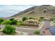 Exterior aerial view of home in a neighborhood with mountain views and mature landscaping at 5812 W Spur Dr, Phoenix, AZ 85083