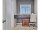 Home office includes a desk, chair, window, and wood details for a functional workspace at 5812 W Spur Dr, Phoenix, AZ 85083