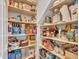 Walk-in pantry features an abundance of shelving for storing food, kitchen items, and paper goods at 5812 W Spur Dr, Phoenix, AZ 85083