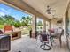 Covered patio with outdoor kitchen, dining area, and seating, perfect for entertaining at 5812 W Spur Dr, Phoenix, AZ 85083