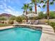 Beautiful pool with waterfall and comfortable lounge chairs surrounded by lush landscaping at 5812 W Spur Dr, Phoenix, AZ 85083