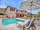 Inviting pool area with lounge chairs and umbrella, creating a relaxing outdoor retreat at 5812 W Spur Dr, Phoenix, AZ 85083