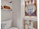 Stylish powder room featuring a vessel sink, decorative mirror, and open shelving at 5812 W Spur Dr, Phoenix, AZ 85083