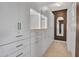 Spacious closet features white cabinets, drawers and shelves, and a full-length mirror at 5812 W Spur Dr, Phoenix, AZ 85083