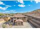 Aerial view of a two-story home with desert landscaping and a neighborhood surrounded by mountains at 6202 W Maya Dr, Phoenix, AZ 85083