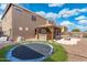 A spacious backyard with a covered bar, pool, fire pit, trampoline, and artificial turf at 6202 W Maya Dr, Phoenix, AZ 85083