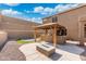 Outdoor covered bar and patio area next to fire pit, artificial turf, and retaining wall at 6202 W Maya Dr, Phoenix, AZ 85083