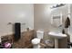 Half bathroom with a round mirror above pedestal sink, patterned tile accent, and neutral paint at 6202 W Maya Dr, Phoenix, AZ 85083
