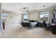 Spacious main bedroom with neutral carpet, ceiling fan, three large windows, and a desk area at 6202 W Maya Dr, Phoenix, AZ 85083