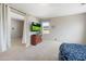 A bedroom area features a small television, dresser, carpet flooring, and light colored walls at 6202 W Maya Dr, Phoenix, AZ 85083