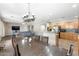 Open dining area and kitchen with a large table, hardwood floors, and an island at 6202 W Maya Dr, Phoenix, AZ 85083