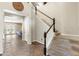 Entryway featuring carpeted stairs, brown tile floors, and an open view into the living room at 6202 W Maya Dr, Phoenix, AZ 85083